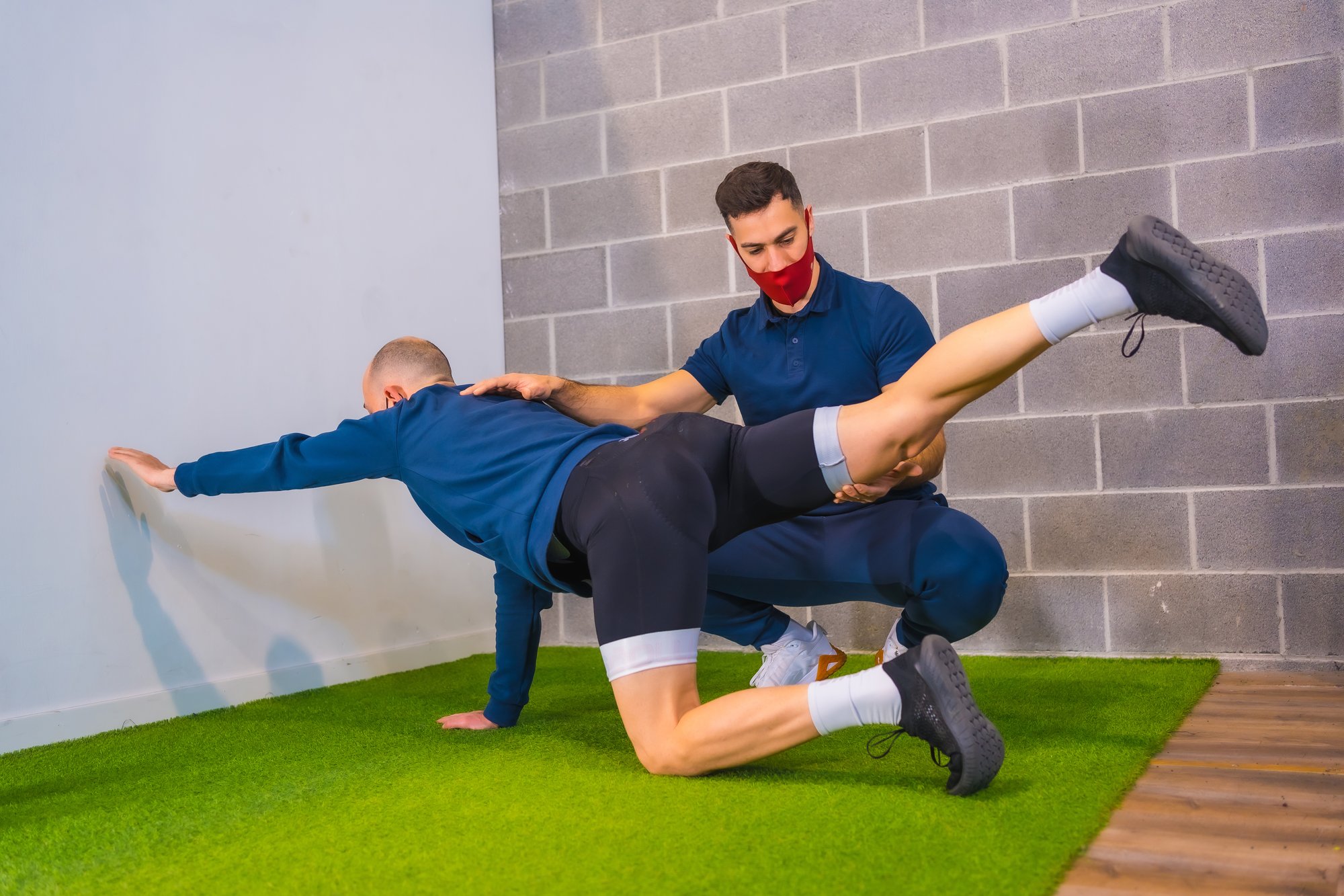 Sports Physical Therapist Correcting Stretching